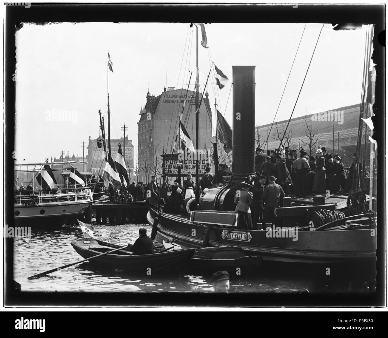 N/A. Nederlands: Beschrijving De Ruijterkade  Steiger 9. Vertrek H.M. Koningin Wilhelmina per Alkmaar Packet naar Zaandam. Op de achtergrond de overkapping van het Centraal Station.  Documenttype foto  Vervaardiger Olie``, Jacob (1834-1905)  Collectie Collectie Jacob Olie Jbz.  Datering 17 april 1899  Geografische naam De Ruijterkade  Inventarissen http://stadsarchief.amsterdam.nl/archief/10019 Afbeeldingsbestand 10019A001227 Generated with Dememorixer . 17 April 1899.   Jacob Olie  (1834–1905)     Alternative names Jacob Olie Jbz. Jacob Olie Jbzn.  Description Dutch photographer  Date of birt Stock Photo